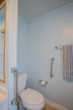 Bathroom featuring toilet and tile patterned flooring