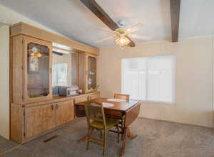 Carpeted dining area with built-in shelving