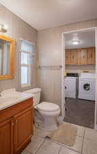 Bathroom with wooden walls, independent  toilet, vanity, and hardwood / wood-style flooring