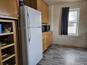 Kitchen featuring LVP flooring and white fridge