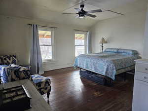 Bedroom featuring ceiling fan, wood flooring, vaulted ceiling, and multiple windows