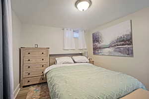 Bedroom with light hardwood / wood-style floors