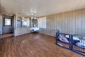 Interior space with wooden walls and dark wood-type flooring