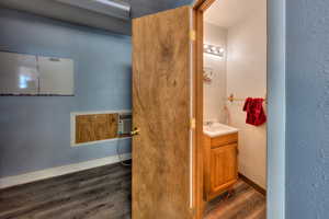 Bathroom with vanity and wood-type flooring