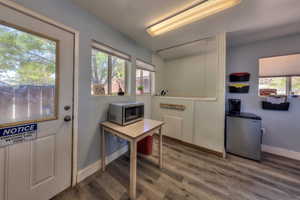 Doorway with a wealth of natural light and wood-type flooring