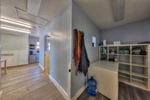 Hallway with hardwood / wood-style flooring