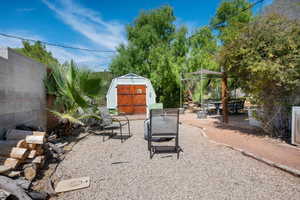 View of patio / terrace featuring a storage unit