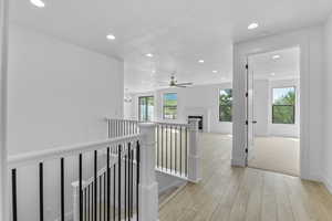 Hall featuring light hardwood / wood-style floors and a textured ceiling