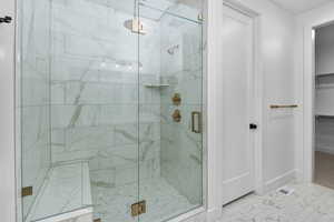 Bathroom featuring walk in shower and tile patterned flooring