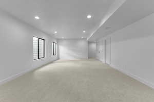 Empty room with light colored carpet