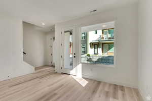 Entrance foyer with light hardwood / wood-style flooring