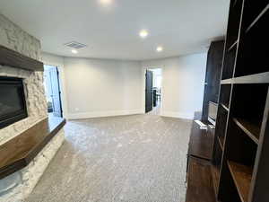 Carpeted living room with a fireplace