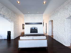 Unfurnished living room featuring dark wood-type flooring and a fireplace