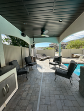 View of patio with a fenced in pool and outdoor lounge area