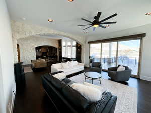 Living room featuring dark hardwood / wood-style floors and ceiling fan