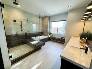 Bathroom featuring tile patterned floors, double sink vanity, and an enclosed shower