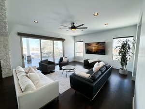 Living room featuring dark hardwood / wood-style floors and ceiling fan