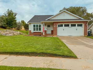 View of front facade with a garage and a front lawn