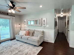 Living room with hardwood / wood-style flooring, a healthy amount of sunlight, and ceiling fan