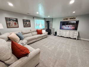 Living room with a wood stove and carpet