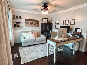 Office featuring dark hardwood / wood-style floors, ceiling fan, and ornamental molding