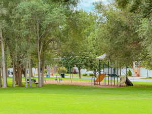 Surrounding community featuring a playground and a lawn