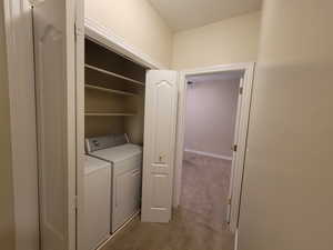 Laundry Area off Main Hallway featuring view of Guest Bedroom on Main Level