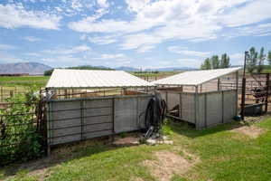 Exterior space featuring a mountain view, a rural view, and an outdoor structure