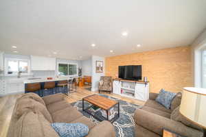 Living room with laminate flooring and a healthy amount of sunlight