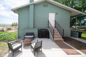 Exterior space with a patio area and an outdoor fire pit