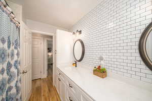 Bathroom featuring laminate flooring and vanity