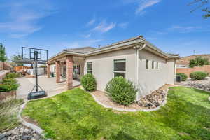 Back of house featuring a patio area, central air condition unit, and a yard