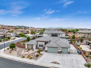 View of front of home with a mountain view and a garage