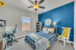 Carpeted bedroom with ceiling fan