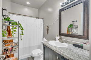 Bathroom featuring vanity, toilet, and hardwood / wood-style flooring