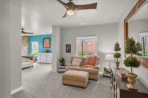 Sitting room featuring ceiling fan and light colored carpet