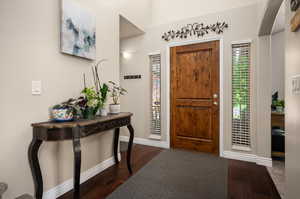 Entrance foyer featuring dark hardwood / wood-style floors