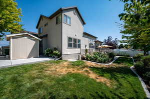 View of side of home featuring a yard