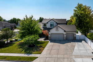 View of front of house featuring a garage and a front lawn