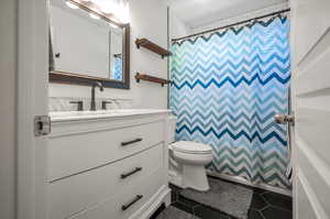 Bathroom with vanity, tile patterned flooring, and toilet