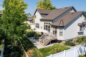 Rear view of house with a patio and a yard