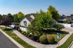 View of front of home with solar panels and a front yard