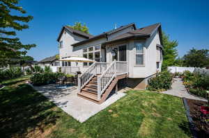 Rear view of house featuring a yard and a patio area