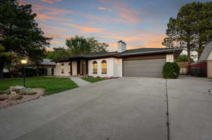 Prairie-style house featuring a garage and a yard