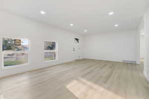 Unfurnished living room featuring light wood-type flooring