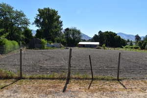 View of fenced horse pasture with a mountain view and a rural view