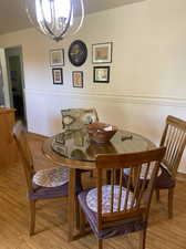 Dining space featuring light hardwood / wood-style floors and an inviting chandelier