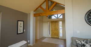 Foyer entrance featuring tile patterned flooring and high vaulted ceiling