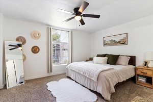 Bedroom featuring carpet and ceiling fan