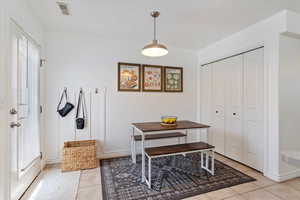 Home office with a wealth of natural light and light tile patterned floors